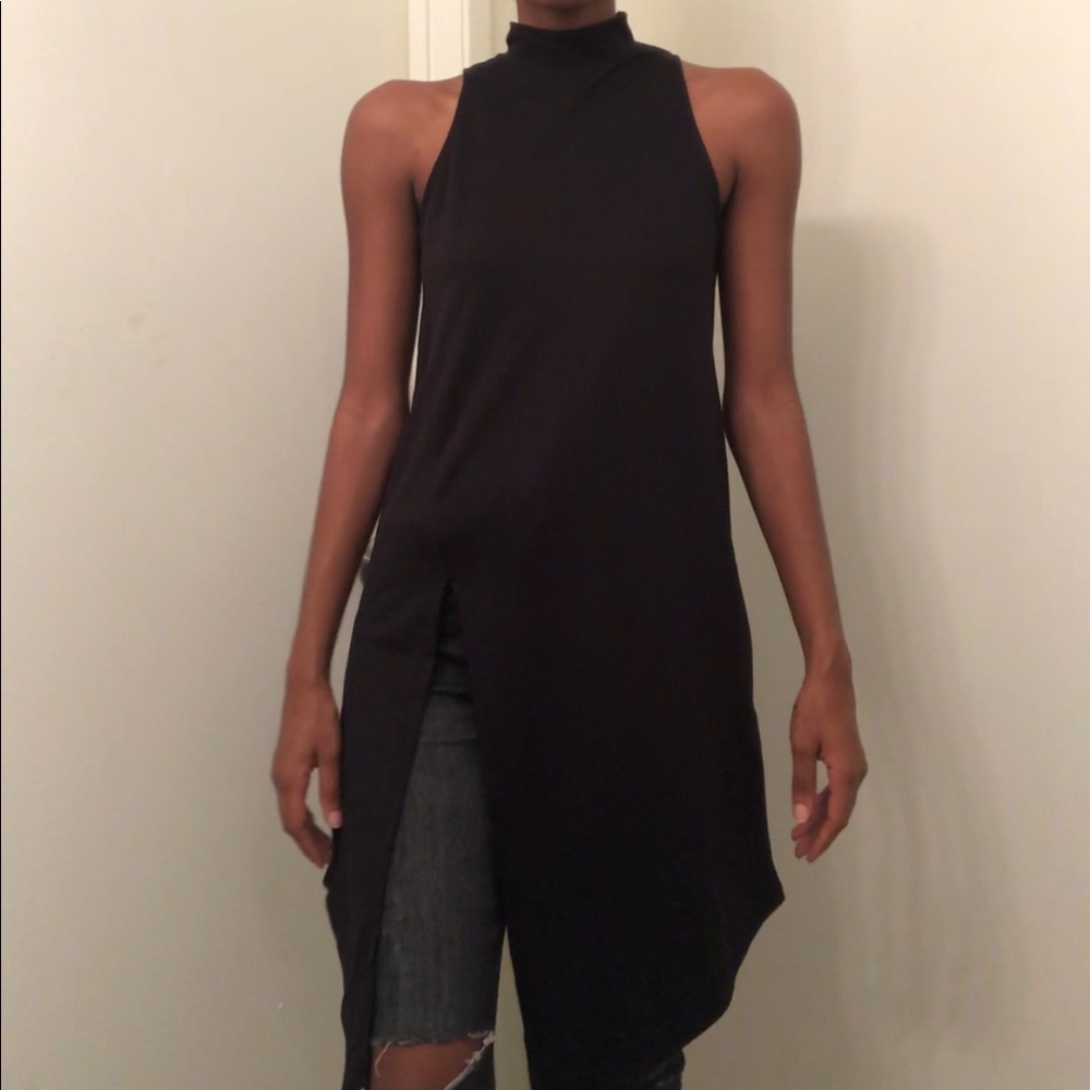 Sleeveless black asymmetrical mock neck top w/slit